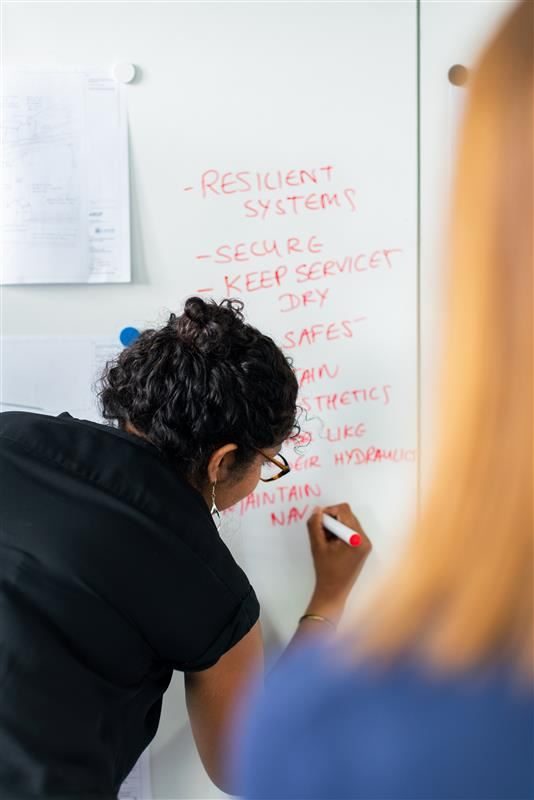 AI and ML security expert mapping resilient systems on a whiteboard